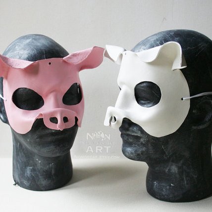 Photo Showing a white and a pink pig mask
